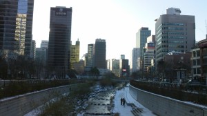 The stream used to be a road, the tall buildings of Myeong-dong surround it.